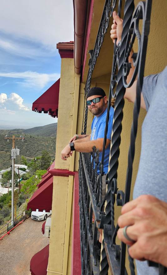 Matt looking out from the hotel balcony ironwork