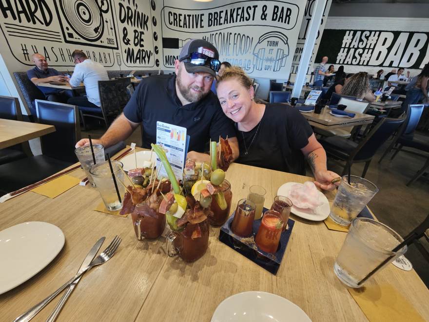 Two of the crew at Hash Kitchen behind loaded bloody marys