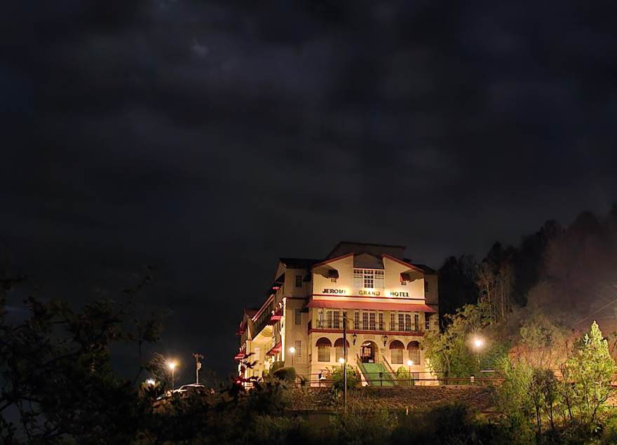 Jerome Grand Hotel lit at night on the hillside
