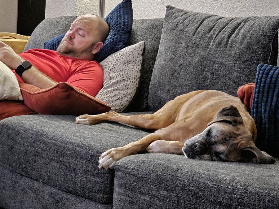 Matt asleep on the couch with the dog