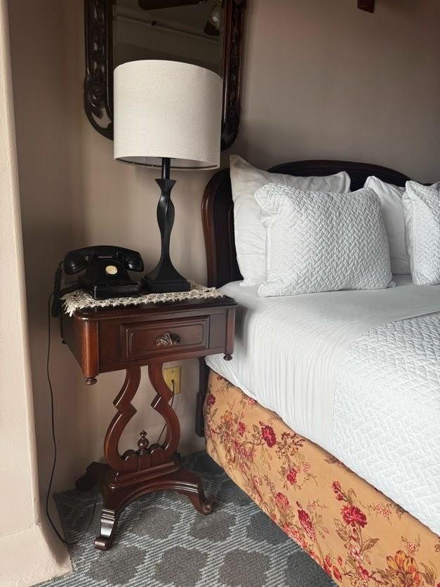Hotel room with antique telephone beside the bed