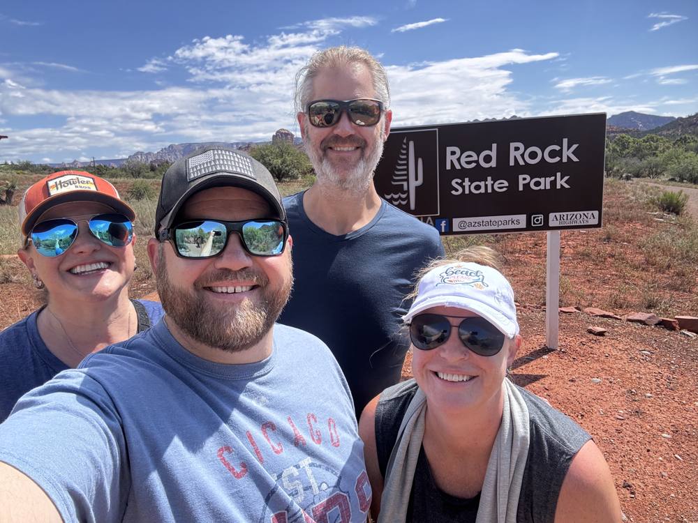 Four-person selfie at the Red Rock State Park sign