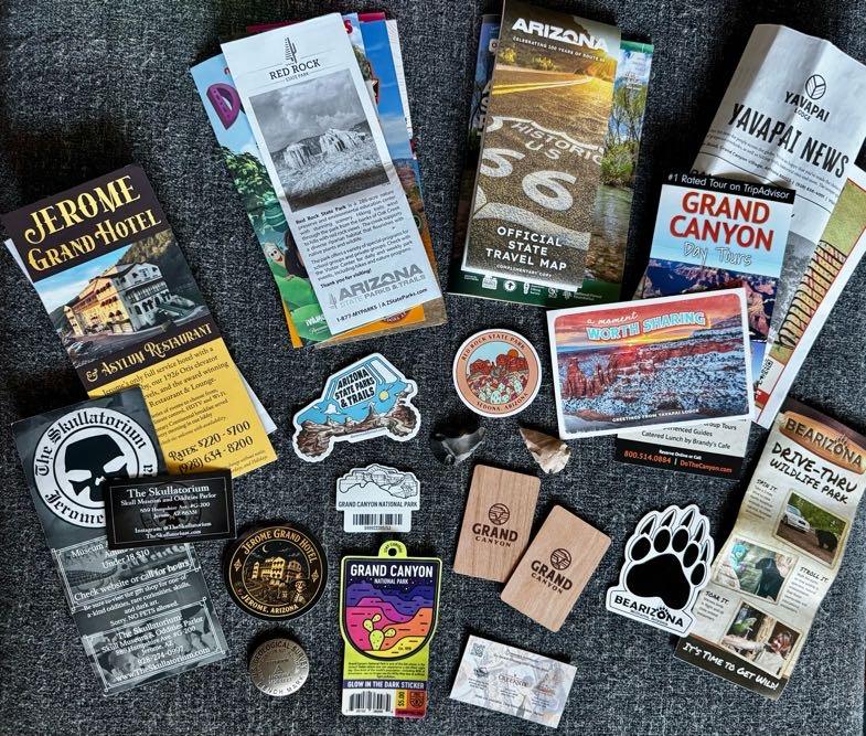 Flat lay of trip souvenirs, stickers, brochures