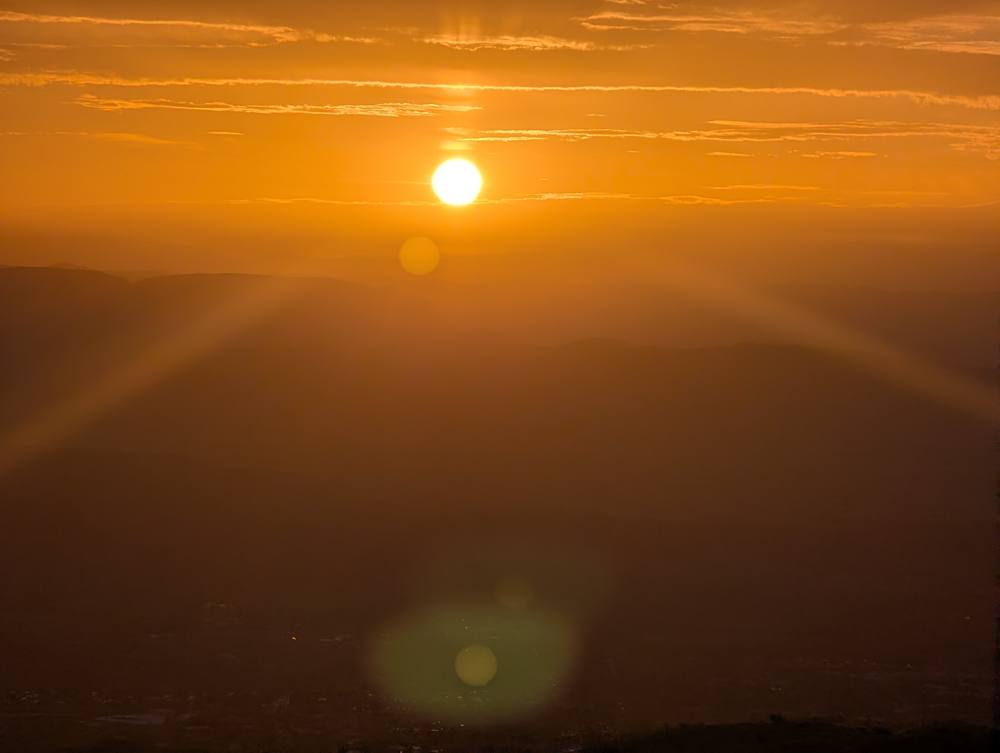 Full orange sunrise over the valley